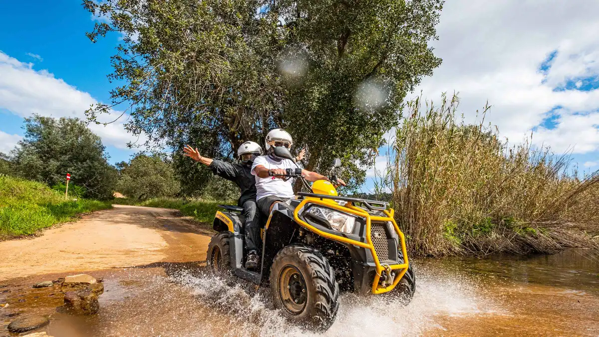 Quad bikes raising dust on a gravel track in the hills near Paderne inland from Albufeira, one of the off-road things to do in Albufeira, Algarve